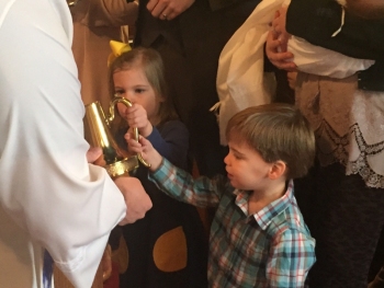 Young family members take an active role in baptism.