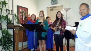 Singers and ukulele players lead St. Mary's song.